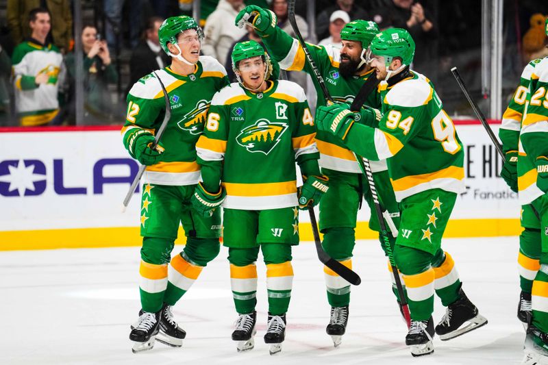 Nov 3, 2024; Saint Paul, Minnesota, USA; Minnesota Wild left wing Matt Boldy (12) celebrates with defenseman Jared Spurgeon (46) following the game against the Toronto Maple Leafs at Xcel Energy Center. Mandatory Credit: Brace Hemmelgarn-Imagn Images