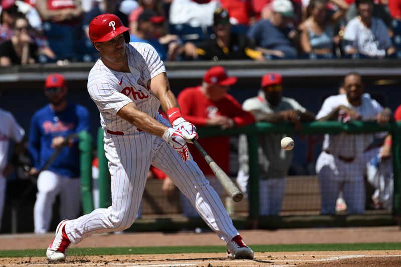 Mar 18, 2024; Clearwater, Florida, USA; Philadelphia Phillies catcher J.T. Realmuto (10) hits a single in the first inning of the spring training game against the Pittsburgh Pirates at BayCare Ballpark. Mandatory Credit: Jonathan Dyer-USA TODAY Sports