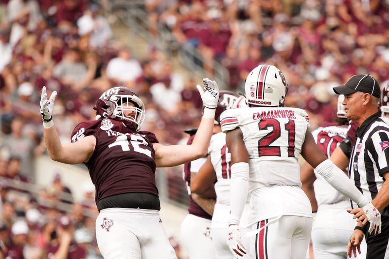 Oct 28, 2023; College Station, Texas, USA; Texas A&M Aggies defensive back Kent Robinson (42) is blocked by South Carolina Gamecocks defensive back Nick Emmanwori (21) during the second quarter at Kyle Field. Mandatory Credit: Dustin Safranek-USA TODAY Sports