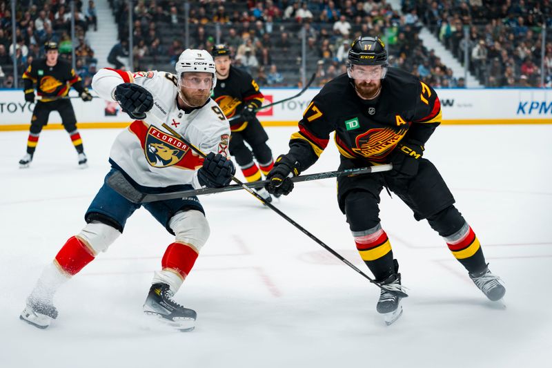 Mar 17, 2026; Vancouver, British Columbia, CAN; Florida Panthers forward Sam Bennett (9) battles with Vancouver Canucks defenseman Filip Hronek (17) in the first period at Rogers Arena. Mandatory Credit: Bob Frid-Imagn Images