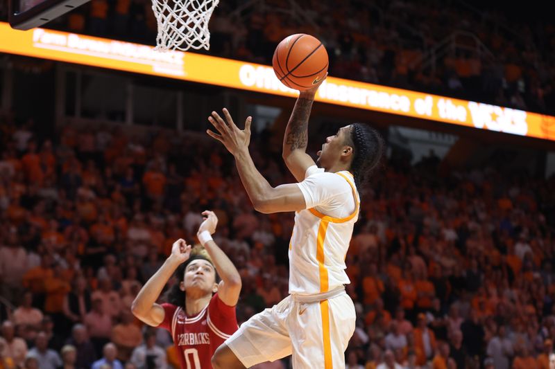 Feb 28, 2023; Knoxville, Tennessee, USA; Tennessee Volunteers guard Zakai Zeigler (5) goes to the basket against the Arkansas Razorbacks during the first half at Thompson-Boling Arena. Mandatory Credit: Randy Sartin-USA TODAY Sports