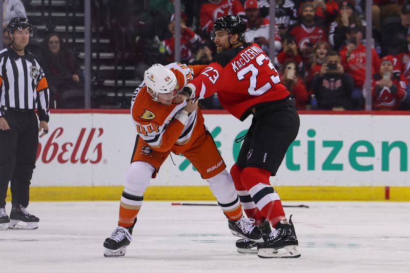 Oct 27, 2024; Newark, New Jersey, USA; Anaheim Ducks left wing Ross Johnston (44) and New Jersey Devils left wing Kurtis MacDermid (23) fight during the first period at Prudential Center. Mandatory Credit: Ed Mulholland-Imagn Images