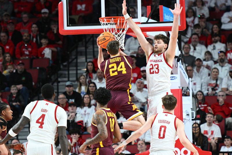 Mar 1, 2025; Lincoln, Nebraska, USA;  Nebraska Cornhuskers forward Andrew Morgan (23) defends a shot attempt from Minnesota Golden Gophers guard Brennan Rigsby (24) during the first half at Pinnacle Bank Arena. Mandatory Credit: Steven Branscombe-Imagn Images