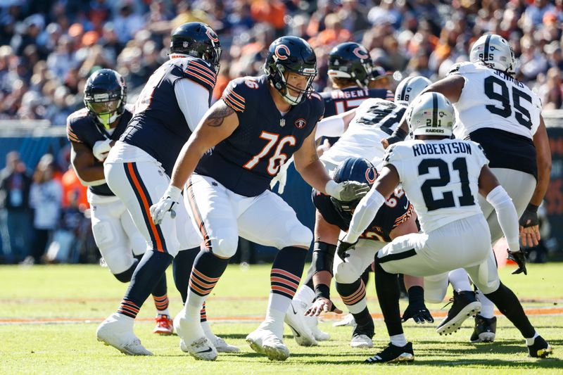 Chicago Bears offensive tackle Teven Jenkins (76) blocks against Las Vegas Raiders cornerback Amik Robertson (21) during the first half of an NFL football game, Sunday, Oct. 22, 2023, in Chicago. (AP Photo/Kamil Krzaczynski)