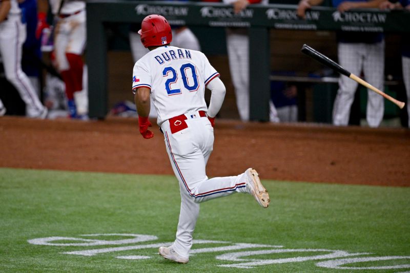 May 16, 2023; Arlington, Texas, USA; Texas Rangers shortstop Ezequiel Duran (20) flips his bat after he hits a home run against the Atlanta Braves during the eighth inning at Globe Life Field. Mandatory Credit: Jerome Miron-USA TODAY Sports