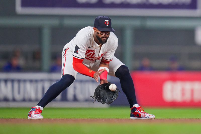 Aug 12, 2024; Minneapolis, Minnesota, USA; Minnesota Twins shortstop Willi Castro (50) fields a ground ball against the Kansas City Royals in the seventh inning at Target Field. Mandatory Credit: Brad Rempel-USA TODAY Sports