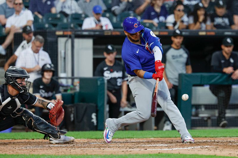 Aug 10, 2024; Chicago, Illinois, USA; Chicago Cubs third baseman Isaac Paredes (17) hits one-run double against the Chicago White Sox during the fifth inning at Guaranteed Rate Field. Mandatory Credit: Kamil Krzaczynski-USA TODAY Sports