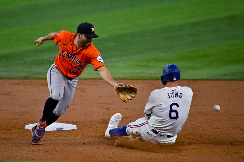 Aug 7, 2024; Arlington, Texas, USA;  Texas Rangers third baseman Josh Jung (6) advances to second base as Houston Astros second baseman Jose Altuve (27) cannot field the throw during the second inning at Globe Life Field. Mandatory Credit: Jerome Miron-USA TODAY Sports