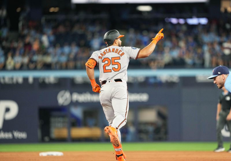 Aug 7, 2024; Toronto, Ontario, CAN; Baltimore Orioles right fielder Anthony Santander (25) runs the bases and celebrates hitting a home run against the Toronto Blue Jays during the eighth inning at Rogers Centre. Mandatory Credit: Nick Turchiaro-USA TODAY Sports