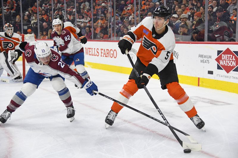 Nov 18, 2024; Philadelphia, Pennsylvania, USA; Philadelphia Flyers defenseman Egor Zamula (5) clears the puck away from Colorado Avalanche right wing Logan O'Connor (25) during the second period at Wells Fargo Center. Mandatory Credit: Eric Hartline-Imagn Images