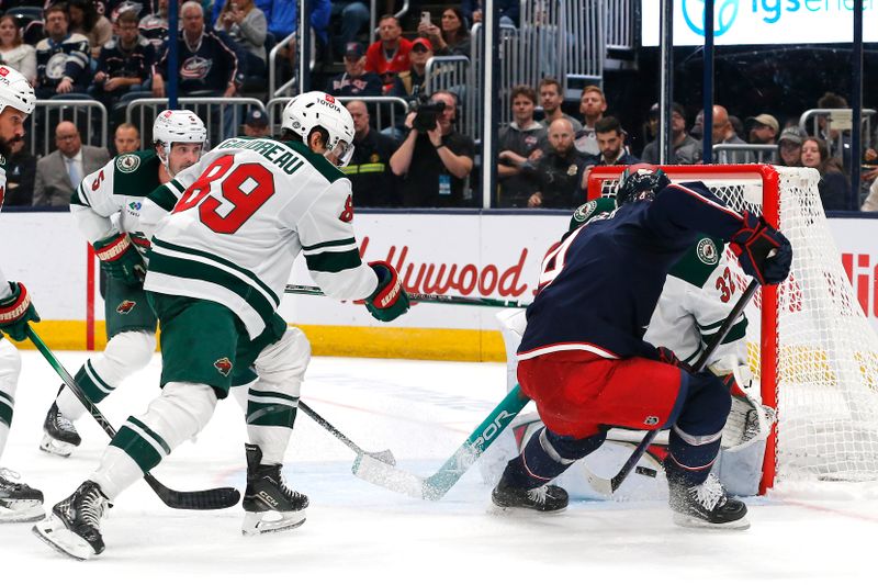 Oct 19, 2024; Columbus, Ohio, USA; Minnesota Wild goalie Filip Gustavsson (32) makes a save on the shot from Columbus Blue Jackets center Cole Sillinger (4) during the second period  at Nationwide Arena. Mandatory Credit: Russell LaBounty-Imagn Images