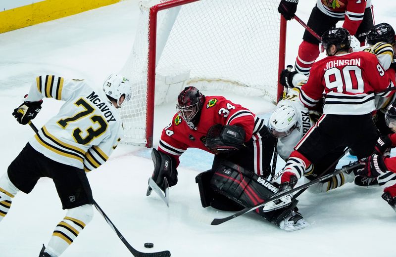 Oct 24, 2023; Chicago, Illinois, USA; Boston Bruins defenseman Charlie McAvoy (73) shoots the puck on Chicago Blackhawks goaltender Petr Mrazek (34) during the second period at United Center. Mandatory Credit: David Banks-USA TODAY Sports