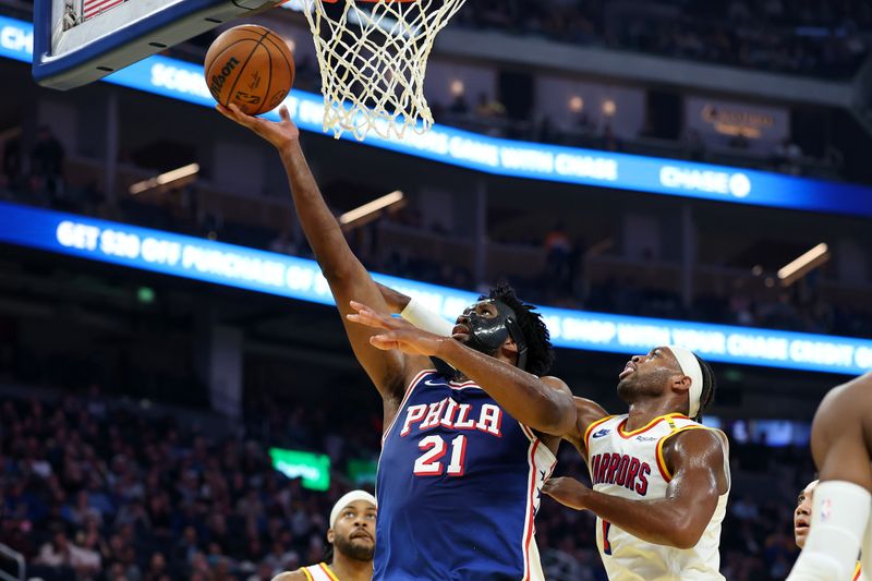 SAN FRANCISCO, CALIFORNIA - JANUARY 02: Joel Embiid #21 of the Philadelphia 76ers goes up for a shot on Buddy Hield #7 of the Golden State Warriors in the first half at Chase Center on January 02, 2025 in San Francisco, California. NOTE TO USER: User expressly acknowledges and agrees that, by downloading and/or using this photograph, user is consenting to the terms and conditions of the Getty Images License Agreement.   (Photo by Ezra Shaw/Getty Images)