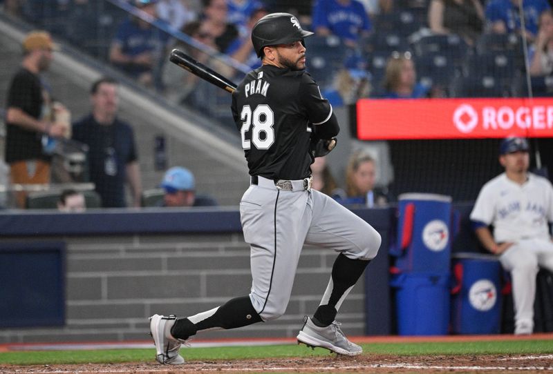 May 21, 2024; Toronto, Ontario, CAN;  Chicago White Sox center fielder Tommy Pham (28) hits a single against the Toronto Blue Jays in the seventh inning at Rogers Centre. Mandatory Credit: Dan Hamilton-USA TODAY Sports