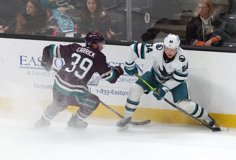 Nov 12, 2023; Anaheim, California, USA; San Jose Sharks right wing Givani Smith (54) passes against Anaheim Ducks center Sam Carrick (39) during the third period at Honda Center. Mandatory Credit: Jason Parkhurst-USA TODAY Sports