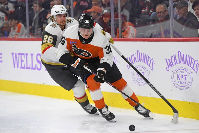 Nov 25, 2024; Philadelphia, Pennsylvania, USA; Philadelphia Flyers defenseman Emil Andrae (36) controls the puck against Vegas Golden Knights right wing Alexander Holtz (26) during the second period at Wells Fargo Center. Mandatory Credit: Eric Hartline-Imagn Images