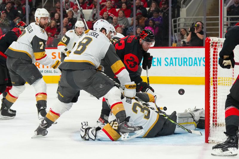 Mar 11, 2023; Raleigh, North Carolina, USA;  Carolina Hurricanes right wing Stefan Noesen (23) misses on his scoring attempt by Vegas Golden Knights goaltender Jonathan Quick (32) and right wing Phil Kessel (8) during the first period at PNC Arena. Mandatory Credit: James Guillory-USA TODAY Sports