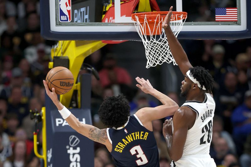 DENVER, COLORADO - JANUARY 10: Julian Strawther #3 of the Denver Nuggets goes to the basket against 	Day'Ron Sharpe #20 of the Brooklyn Nets in the first quarter at Ball Arena on January 10, 2025 in Denver, Colorado.NOTE TO USER: User expressly acknowledges and agrees that, by downloading and or using this photograph, User is consenting to the terms and conditions of the Getty Images License Agreement. (Photo by Matthew Stockman/Getty Images)