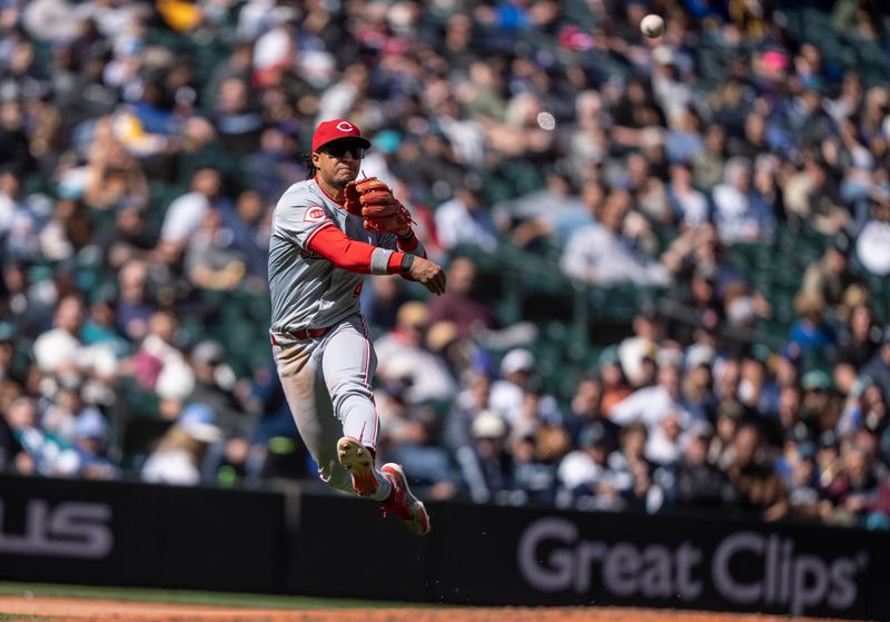 Apr 17, 2024; Seattle, Washington, USA; Cincinnati Reds third baseman Santiago Espinal (4) throws to first base after fielding.a ground ball during the sixth inning against the Seattle Mariners at T-Mobile Park. Mandatory Credit: Stephen Brashear-USA TODAY Sports