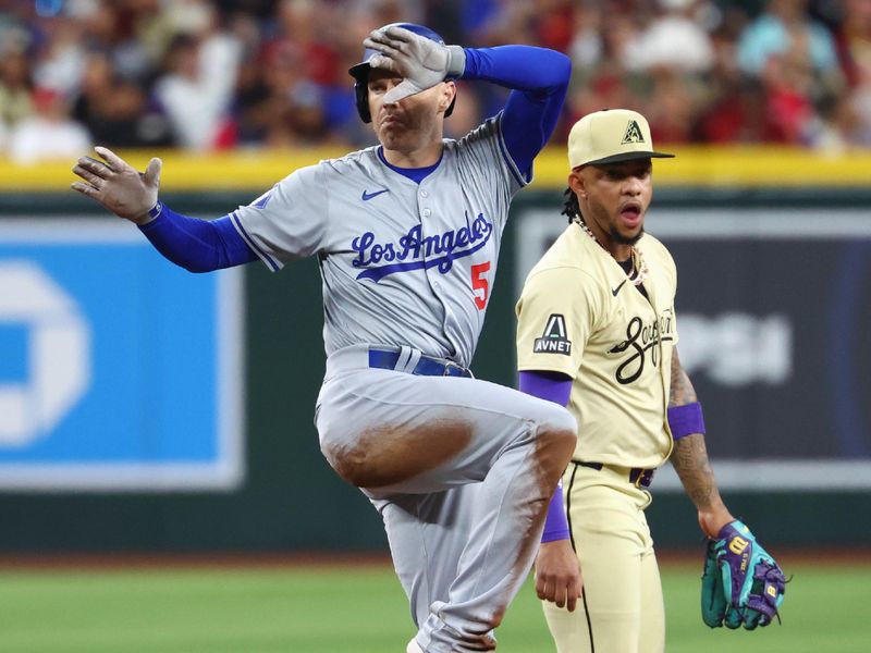 Apr 30, 2024; Phoenix, Arizona, USA; Los Angeles Dodgers first baseman Freddie Freeman celebrates after hitting a fourth inning double against the Arizona Diamondbacks at Chase Field. Mandatory Credit: Mark J. Rebilas-USA TODAY Sports