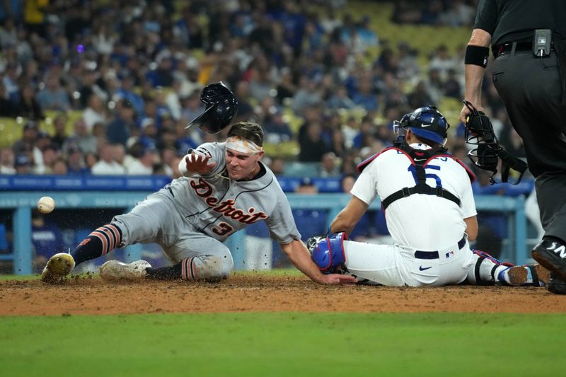 Sep 20, 2023; Los Angeles, California, USA; Detroit Tigers right fielder Kerry Carpenter (30) slides into home plate to beat a throw to Los Angeles Dodgers catcher Austin Barnes (15) to score in the eighth inning at Dodger Stadium. Mandatory Credit: Kirby Lee-USA TODAY Sports