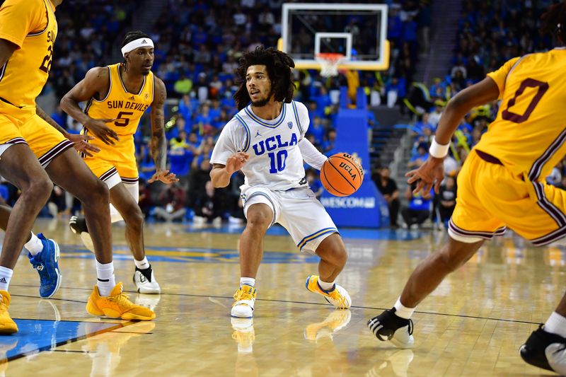 Mar 2, 2023; Los Angeles, California, USA; UCLA Bruins guard Tyger Campbell (10) controls the ball against Arizona State Sun Devils guard DJ Horne (0) during the second half at Pauley Pavilion. Mandatory Credit: Gary A. Vasquez-USA TODAY Sports