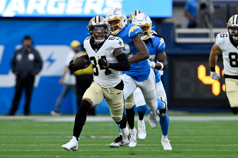 New Orleans Saints wide receiver Lynn Bowden (84) runs past Los Angeles Chargers safety JT Woods (22) during the first half of a preseason NFL football game Sunday, Aug. 20, 2023, in Inglewood, Calif. (AP Photo/Alex Gallardo)