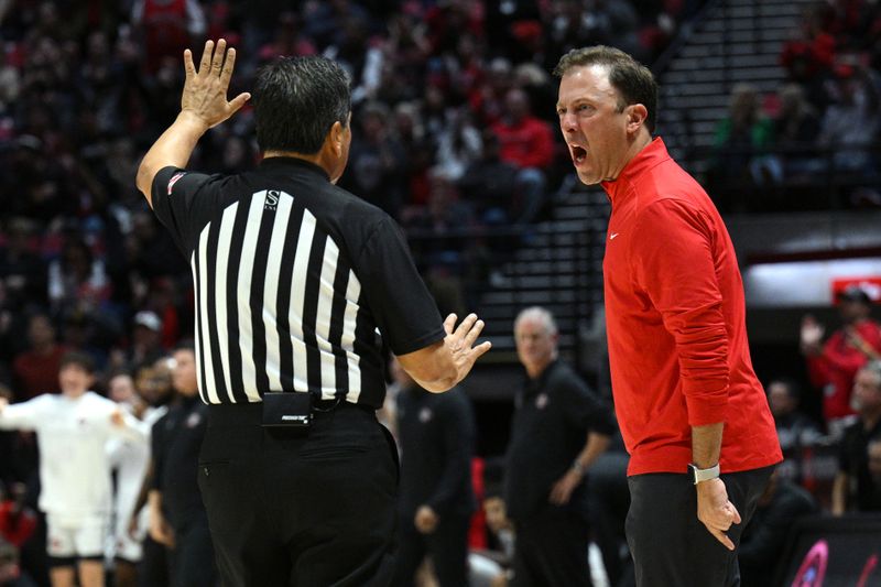 Jan 14, 2023; San Diego, California, USA; New Mexico Lobos head coach Richard Pitino (right) reacts toward an official during the second half against the San Diego State Aztecs at Viejas Arena. Mandatory Credit: Orlando Ramirez-USA TODAY Sports