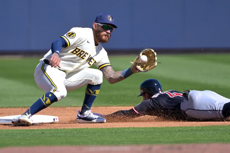 Feb 21, 2026; Phoenix, Arizona, USA;  Cleveland Guardians shortstop Brayan Rocchio (4) is caught stealing by Milwaukee Brewers shortstop Joey Ortiz (3) in the first inning at American Family Fields of Phoenix. Mandatory Credit: Jayne Kamin-Oncea-Imagn Images