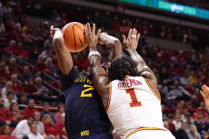 Jan 2, 2026; Ames, Iowa, USA; West Virginia Mountaineers guard Amir Jenkins (2) is defended by Iowa State Cyclones guard Jamarion Batemon (1) during the second half at James H. Hilton Coliseum. Mandatory Credit: Reese Strickland-Imagn Images