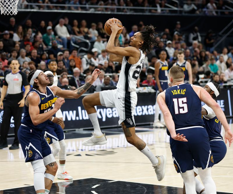 AUSTIN, TX - MARCH 15: Devin Vassell #24 of the San Antonio Spurs goes to the basket against the Denver Nuggets in the first half at Moody Center on March 15, 2024 in Austin, Texas. NOTE TO USER: User expressly acknowledges and agrees that, by downloading and or using this photograph, User is consenting to terms and conditions of the Getty Images License Agreement. (Photo by Ronald Cortes/Getty Images)