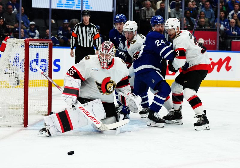 Nov 12, 2024; Toronto, Ontario, CAN; Toronto Maple Leafs center Connor Dewar (24) battles for the puck with Ottawa Senators defenseman Nick Jensen (3) in front of goaltender Linus Ullmark (35) during the first period at Scotiabank Arena. Mandatory Credit: Nick Turchiaro-Imagn Images