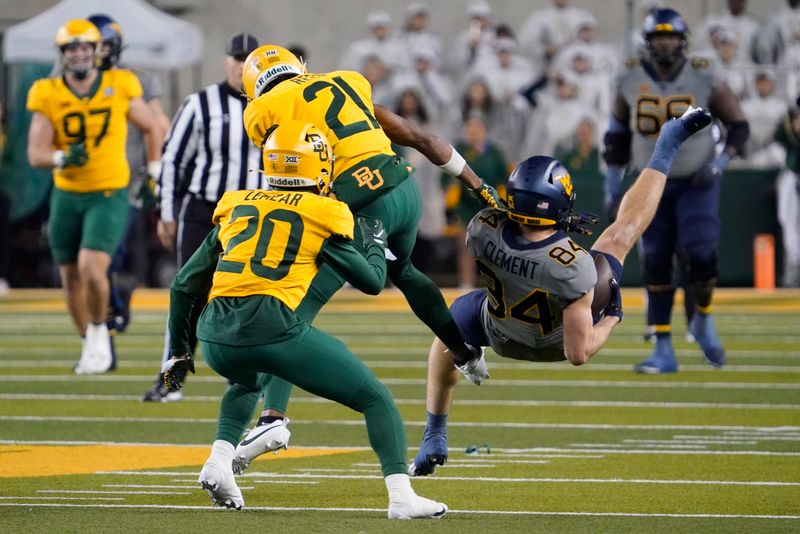 Nov 25, 2023; Waco, Texas, USA; West Virginia Mountaineers wide receiver Hudson Clement (84) makes the catch as Baylor Bears cornerback Chateau Reed (21) defends during the second half at McLane Stadium. Mandatory Credit: Raymond Carlin III-USA TODAY Sports