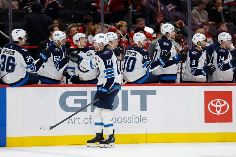 Nov 26, 2025; Washington, District of Columbia, USA; Winnipeg Jets center Gabriel Vilardi (13) celebrates with teammates after scoring a goal against the Washington Capitals during the first period at Capital One Arena. Mandatory Credit: Geoff Burke-Imagn Images