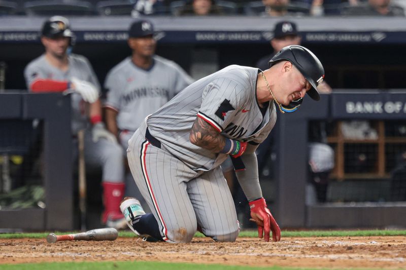 Jun 6, 2024; Bronx, New York, USA; Minnesota Twins third baseman Jose Miranda (64) reacts after being hit by a pitch during the fifth inning against the New York Yankees at Yankee Stadium. Mandatory Credit: Vincent Carchietta-USA TODAY Sports