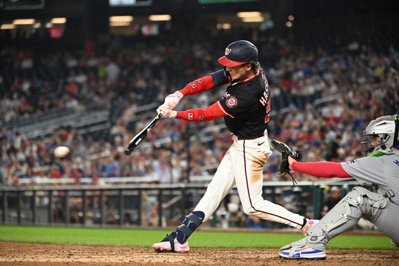 Jun 5, 2025; Washington, District of Columbia, USA; Washington Nationals center fielder Robert Hassell III (57) hits the ball into play during the seventh inning against the Chicago Cubs at Nationals Park. Mandatory Credit: Rafael Suanes-Imagn Images