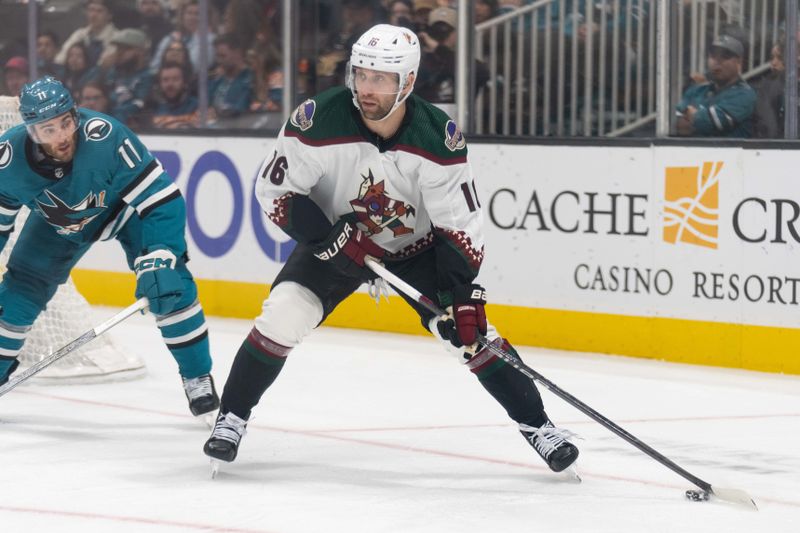 Dec 21, 2023; San Jose, California, USA; Arizona Coyotes left wing Jason Zucker (16) looks to pass the puck during the third period against the San Jose Sharks at SAP Center at San Jose. Mandatory Credit: Stan Szeto-USA TODAY Sports