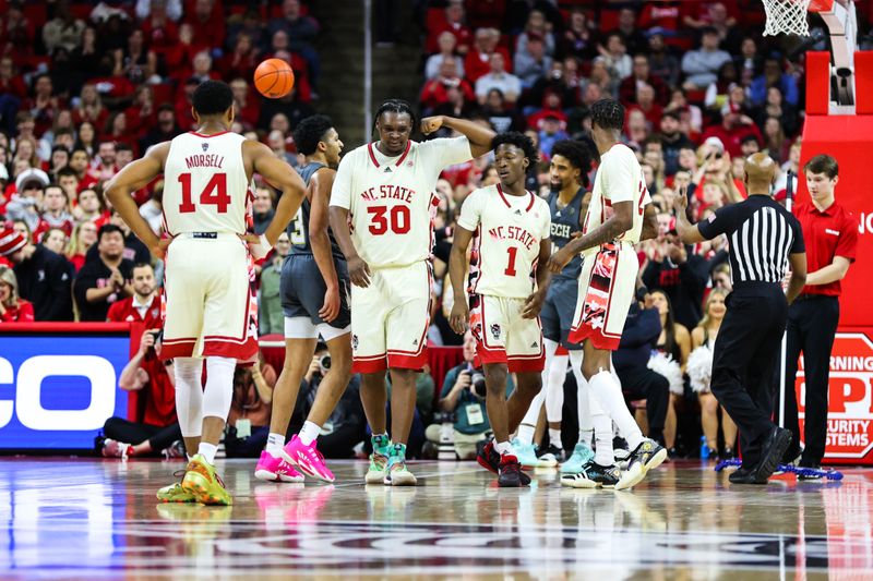 Feb 4, 2023; Raleigh, North Carolina, USA; North Carolina State Wolfpack forward D.J. Burns Jr. (30) celebrates a point with his teammates during the second half of the game against Georgia Tech Yellow Jackets at PNC Arena. Mandatory Credit: Jaylynn Nash-USA TODAY Sports