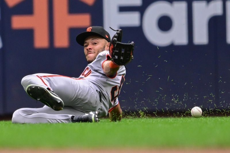 Aug 29, 2024; Milwaukee, Wisconsin, USA; San Francisco Giants center fielder Grant McCray (58) can't catch ball hit by Milwaukee Brewers designated hitter William Contreras (not pictured) for a base hit in the sixth inning at American Family Field. Mandatory Credit: Benny Sieu-USA TODAY Sports