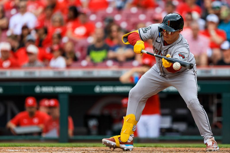 May 9, 2024; Cincinnati, Ohio, USA; Arizona Diamondbacks designated hitter Joc Pederson (3) bunts against the Cincinnati Reds in the ninth inning at Great American Ball Park. Mandatory Credit: Katie Stratman-USA TODAY Sports