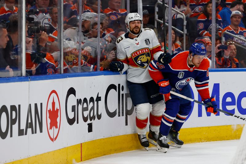 Jun 13, 2024; Edmonton, Alberta, CAN; Edmonton Oilers defenseman Philip Broberg (86) checks Florida Panthers center Sam Reinhart (13) in the third period in game three of the 2024 Stanley Cup Final at Rogers Place. Mandatory Credit: Perry Nelson-USA TODAY Sports