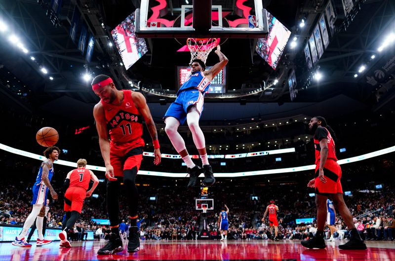 TORONTO, ON - MARCH 31: Tobias Harris #12 of the Philadelphia 76ers drunks against Bruce Brown #11 of the Toronto Raptors during the second half of their basketball game at the Scotiabank Arena on March 31, 2024 in Toronto, Ontario, Canada. NOTE TO USER: User expressly acknowledges and agrees that, by downloading and/or using this Photograph, user is consenting to the terms and conditions of the Getty Images License Agreement. (Photo by Mark Blinch/Getty Images)