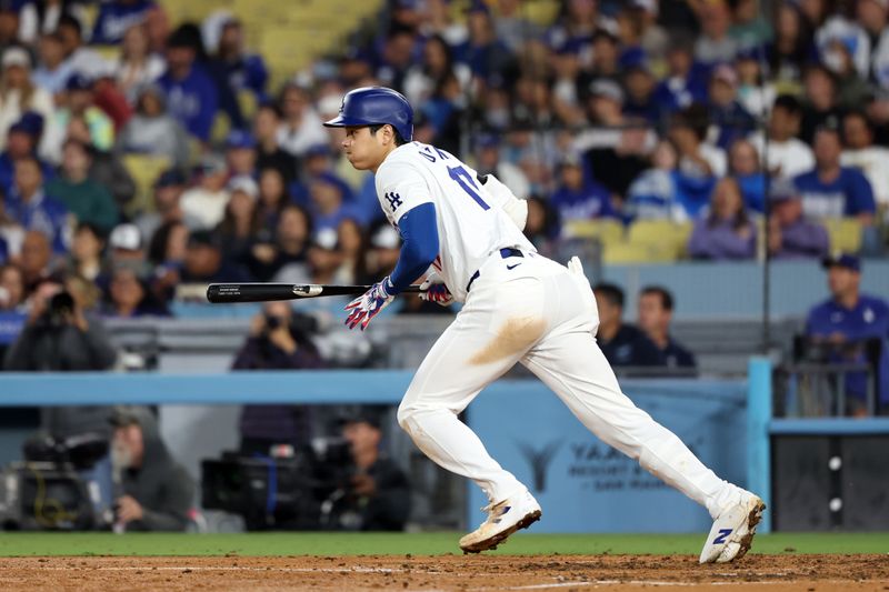 Jun 1, 2024; Los Angeles, California, USA;  Los Angeles Dodgers designated hitter Shohei Ohtani (17) hits a single during the seventh inning against the Colorado Rockies at Dodger Stadium. Mandatory Credit: Kiyoshi Mio-USA TODAY Sports