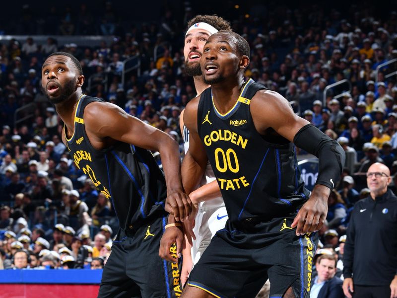 PHOENIX, AZ - NOVEMBER 12: Andrew Wiggins #22 and Jonathan Kuminga #00 of the Golden State Warriors defends against the Dallas Mavericks during the Emirates NBA Cup game on November 12, 2024 at Footprint Center in Phoenix, Arizona. NOTE TO USER: User expressly acknowledges and agrees that, by downloading and or using this photograph, user is consenting to the terms and conditions of the Getty Images License Agreement. Mandatory Copyright Notice: Copyright 2024 NBAE (Photo by Barry Gossage/NBAE via Getty Images)