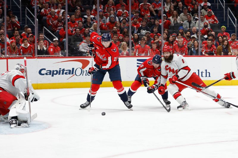 Jan 5, 2024; Washington, District of Columbia, USA; Washington Capitals center Aliaksei Protas (21) controls the puck in front of Carolina Hurricanes goaltender Pyotr Kochetkov (52) in the third period at Capital One Arena. Mandatory Credit: Geoff Burke-USA TODAY Sports