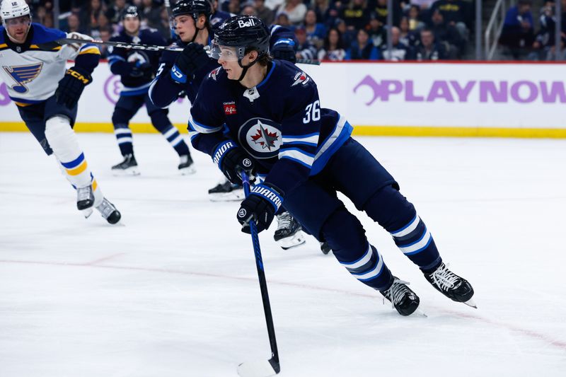 Dec 3, 2024; Winnipeg, Manitoba, CAN;  Winnipeg Jets forward Morgan Barron (36) looks to make a pass against the St. Louis Blues during the first period at Canada Life Centre. Mandatory Credit: Terrence Lee-Imagn Images