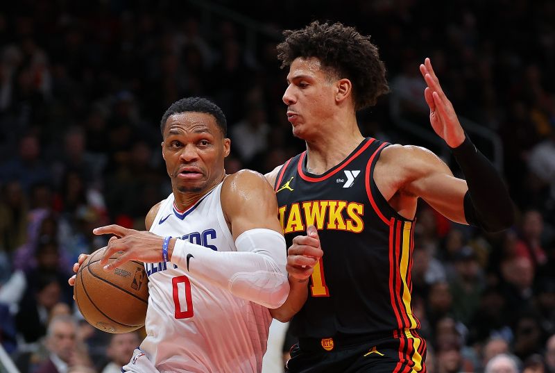 ATLANTA, GEORGIA - FEBRUARY 05:  Russell Westbrook #0 of the LA Clippers drives against Jalen Johnson #1 of the Atlanta Hawks during the fourth quarter at State Farm Arena on February 05, 2024 in Atlanta, Georgia.  NOTE TO USER: User expressly acknowledges and agrees that, by downloading and/or using this photograph, user is consenting to the terms and conditions of the Getty Images License Agreement.  (Photo by Kevin C. Cox/Getty Images)