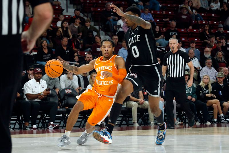 Jan 17, 2023; Starkville, Mississippi, USA; Tennessee Volunteers guard Zakai Zeigler (5) dribbles as Mississippi State Bulldogs forward D.J. Jeffries (0) defends during the first half at Humphrey Coliseum. Mandatory Credit: Petre Thomas-USA TODAY Sports