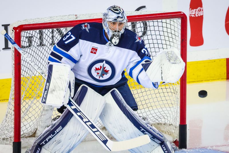 Oct 11, 2023; Calgary, Alberta, CAN; Winnipeg Jets goaltender Connor Hellebuyck (37) guards his net during the warmup period against the Calgary Flames at Scotiabank Saddledome. Mandatory Credit: Sergei Belski-USA TODAY Sports