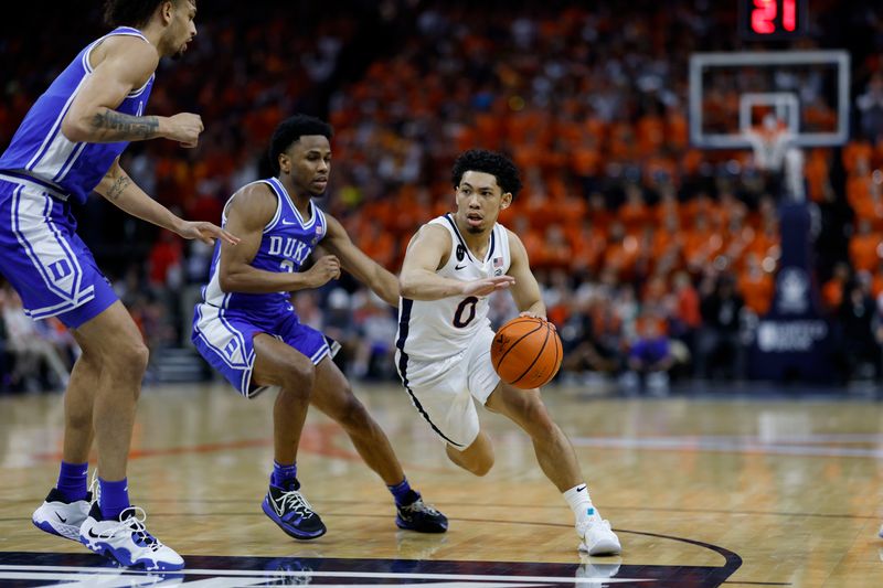 Feb 11, 2023; Charlottesville, Virginia, USA; Virginia Cavaliers guard Kihei Clark (0) drives to the basket as Duke Blue Devils guard Jeremy Roach (3) and Blue Devils center Dereck Lively II (1) defend in the second half at John Paul Jones Arena. Mandatory Credit: Geoff Burke-USA TODAY Sports